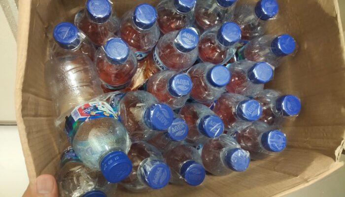 Kotak Misterius di Bandara Timika Ternyata Berisi Puluhan Botol Miras Ilegal